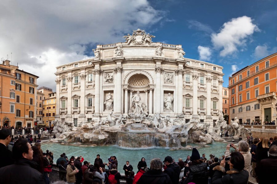 Crowds of visitors around the Trevi Fountain in Rome.