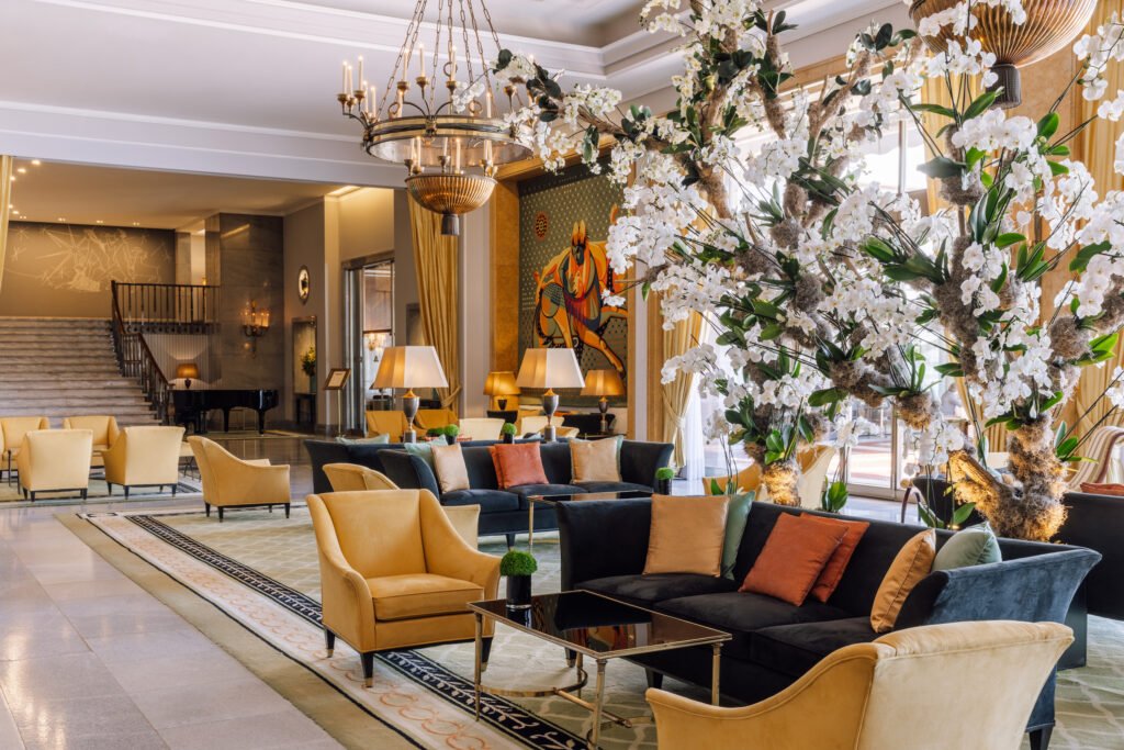 Lobby lounge with flower arrangement and chandelier at Four Seasons Hotel Ritz Lisbon